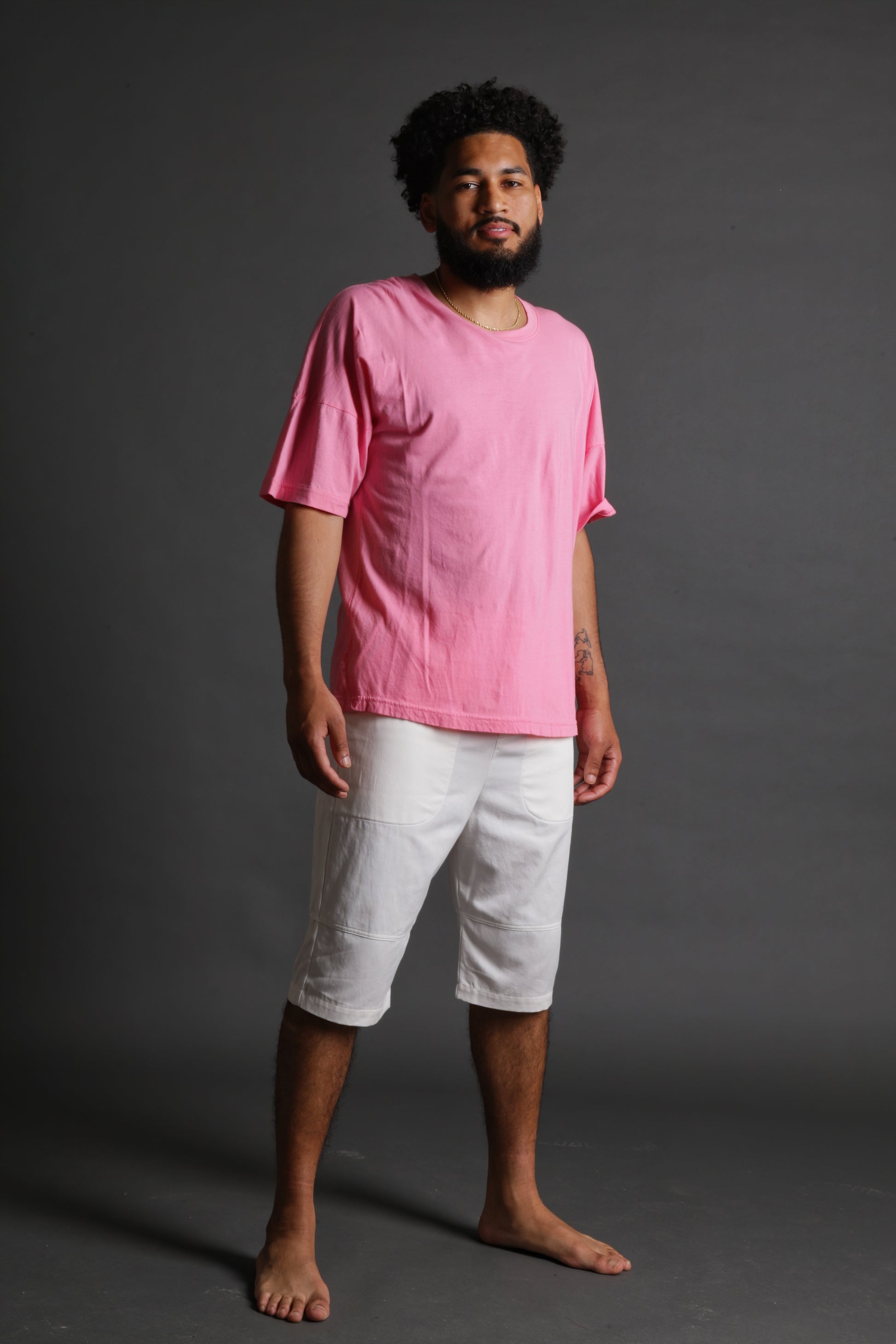 The model is wearing a pink tshirt from Sea Of Sound by Gavin Rossdale with a blank front 