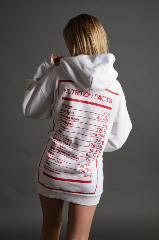 The model is wearing the white and red Righteous Hoodie from Sea Of Sound by Gavin Rossdale with the Nutrition Facts logo on the back.
