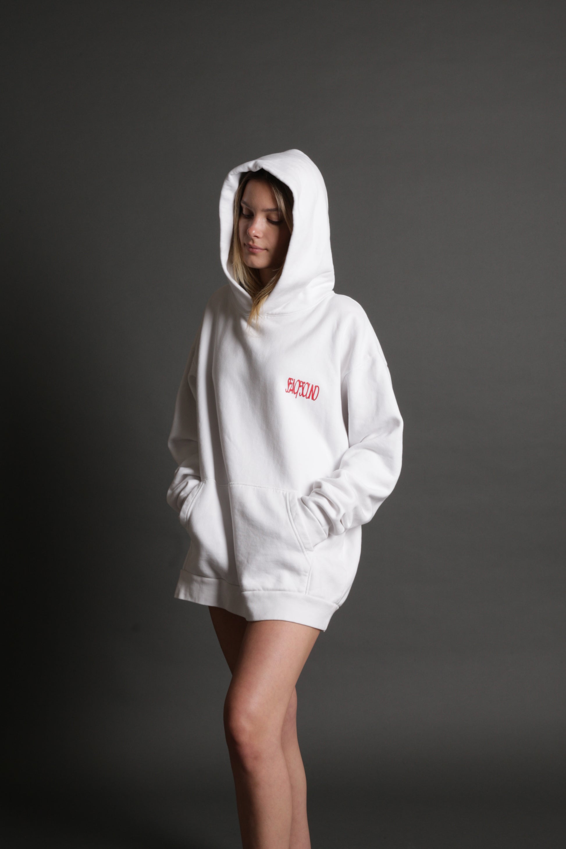 The model is wearing the white and red Righteous Hoodie from Sea Of Sound by Gavin Rossdale with the main Sea Of Sound logo on the front.