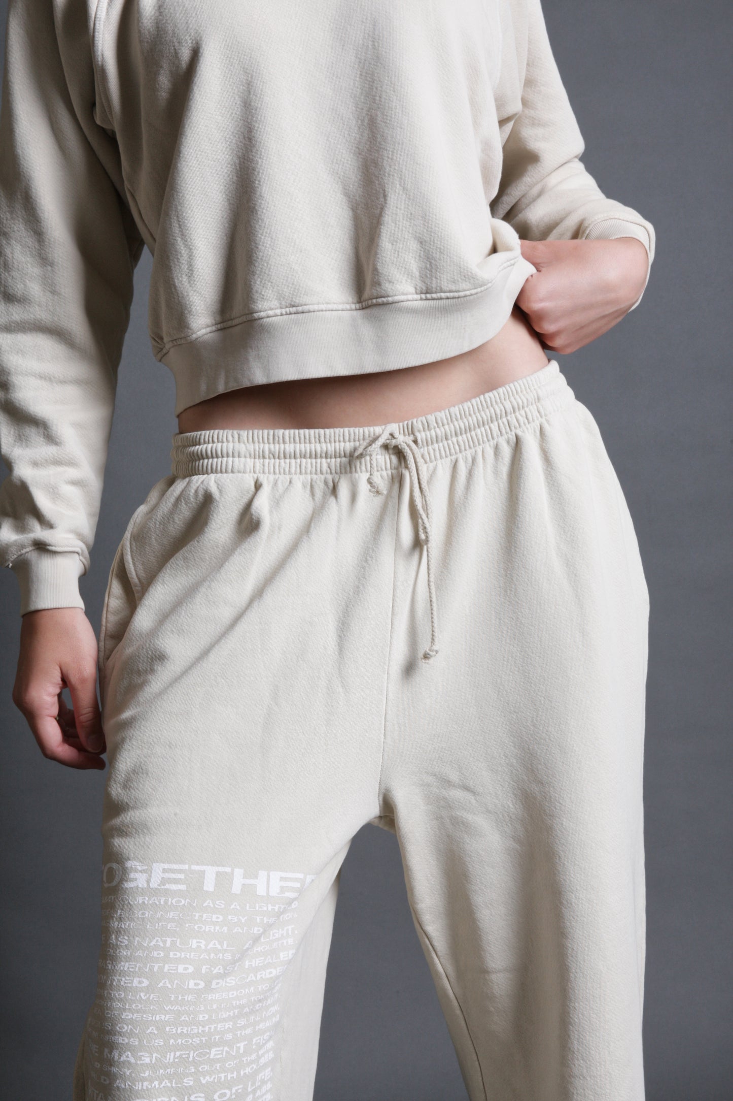 The image is a close up of a model is wearing track pants from Sea Of Sound by Gavin Rossdale with the Together logo on the right leg.