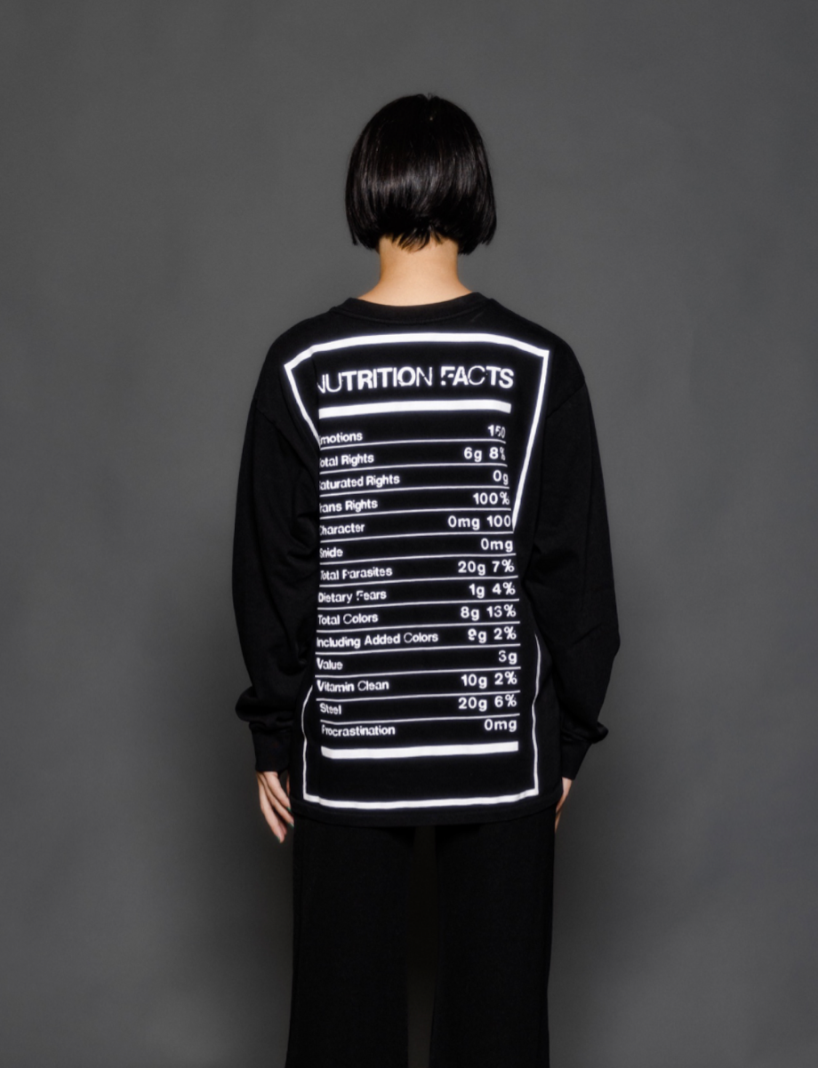 The model is wearing a long sleeve black tshirt from Sea Of Sound by Gavin Rossdale with the Nutrition Facts logo on the back.